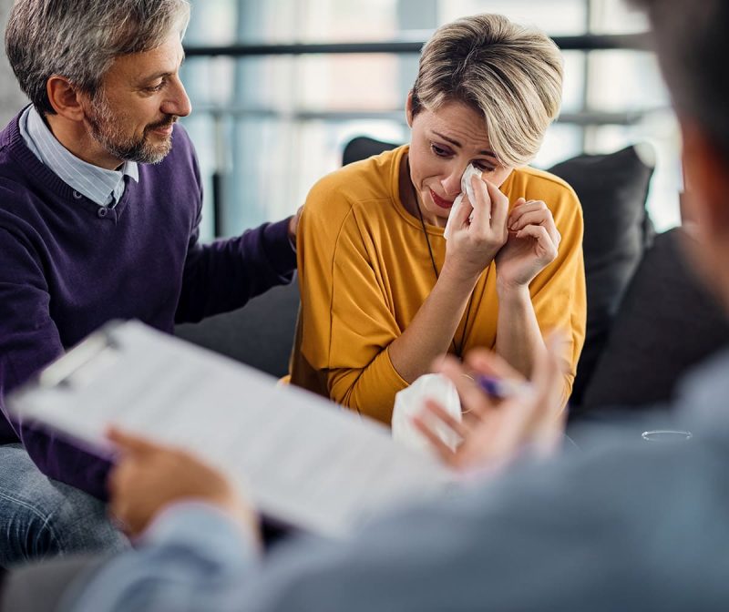 Couple receiving sad news about someone passing away - PayPulse Funeral Cover